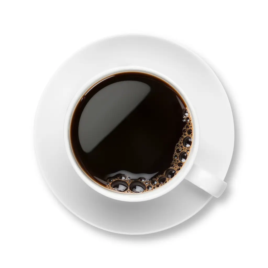 black coffee with bubbles in white cup with saucer